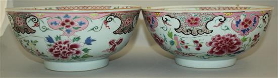 A pair of Chinese famille rose bowls, Qianlong period, 23.3cm, some faults, wood stands